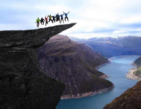 Jumping on the Trolltunga rock in Norway. 